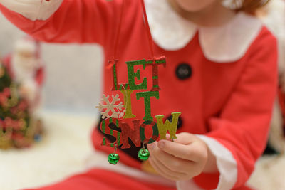 Close-up of girl playing with christmas lights