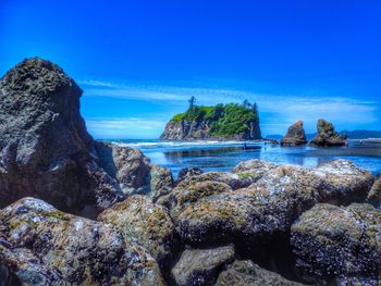 Scenic view of sea against blue sky