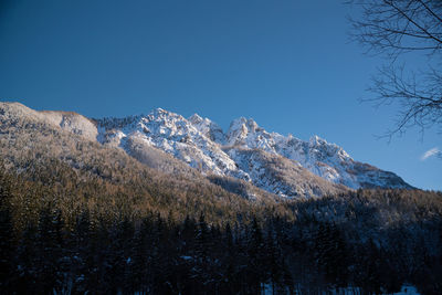 Scenic view of snowcapped mountains against clear sky