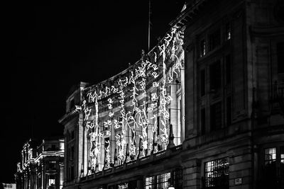 Low angle view of illuminated building at night