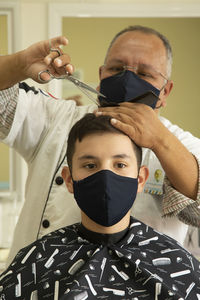 Portrait of boy getting haircut