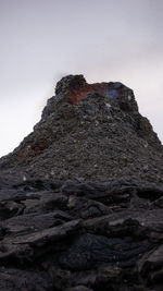 Low angle view of rock formation against sky