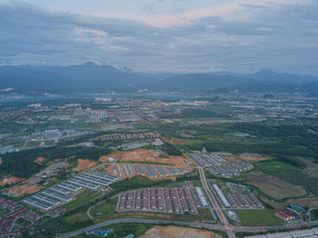 Aerial view of townscape on field against sky
