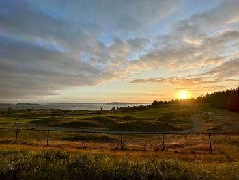 Scenic view of field against sky during sunset