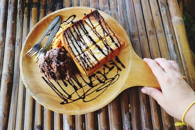 High angle view of hand holding cake