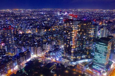 High angle view of illuminated modern buildings in city at night