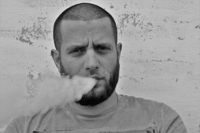 Portrait of man exhaling smoke