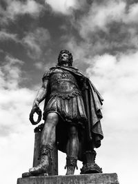 Low angle view of statue of liberty against cloudy sky