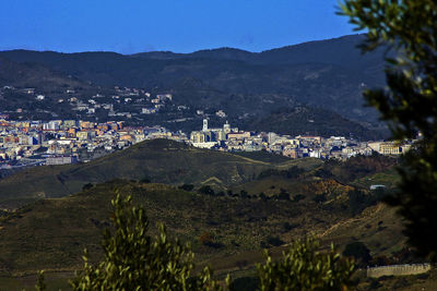 High angle view of townscape and mountains against sky