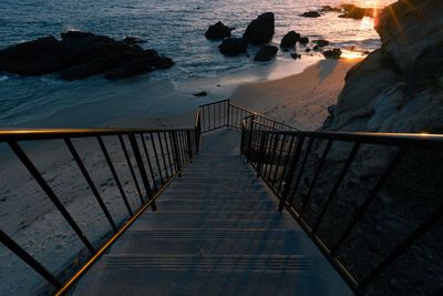 High angle view of staircase by sea against sky