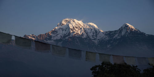 Scenic view of snowcapped mountains against clear sky