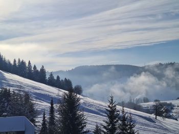 Scenic view of snow covered mountains against sky