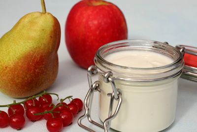 Close-up of apples in glass jar on table