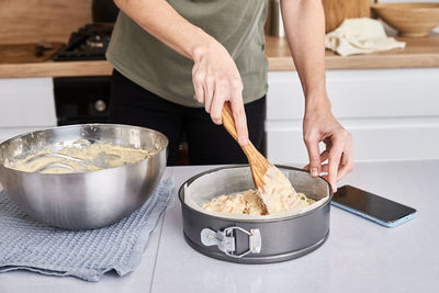 Woman cooking cake at kitchen