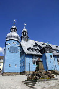 Low angle view of building against clear blue sky