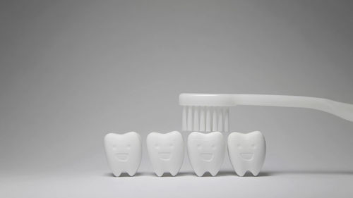 Close-up of glasses on table against white background