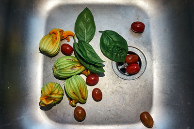 High angle view of fruits and leaves on table