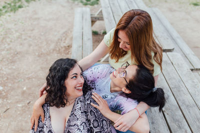 Group of three happy girlfriends embracing and smiling. females enjoy friendship. sorority women.