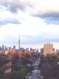 View of cityscape against cloudy sky