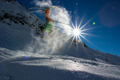 Low angle view of skiing on snow landscape