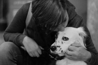 Close-up of woman with dog sitting