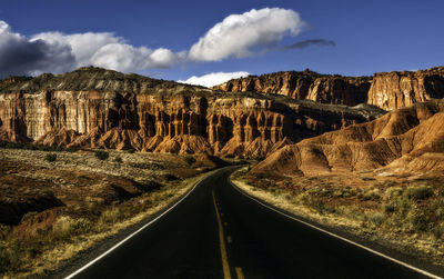 Panoramic view of road leading towards mountains against sky