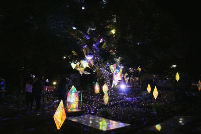 Low angle view of illuminated christmas tree at night