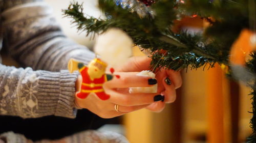 Midsection of woman holding christmas tree
