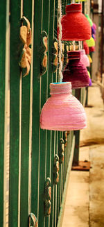 Close-up of various hanging on metal fence