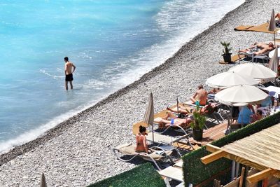 High angle view of people relaxing on beach