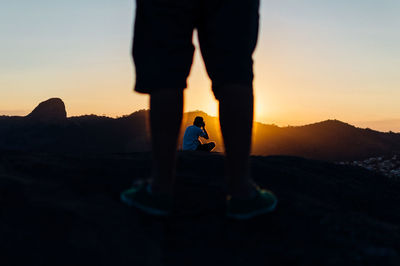 Low section of woman standing on rock