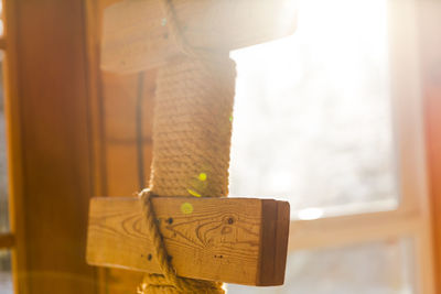 Handmade wooden ladder used for climbing up a bunk bed. cabin-style room setting.