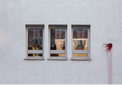 Close-up of window on stained wall