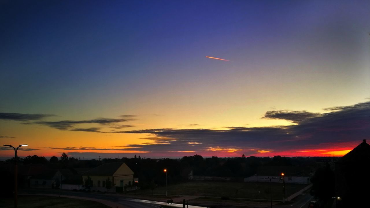 SCENIC VIEW OF SILHOUETTE BUILDINGS AGAINST SKY DURING SUNSET