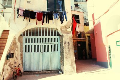 Clothes drying on street amidst buildings in city