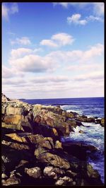 Scenic view of sea against cloudy sky