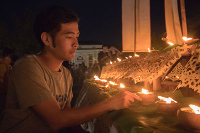 Man holding lit diya during diwali celebration