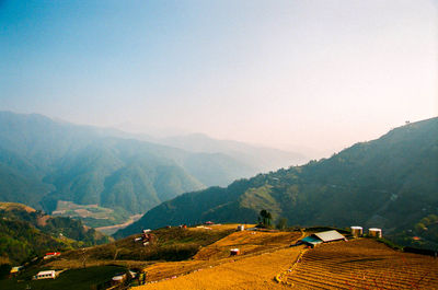 Scenic view of mountains against cloudy sky