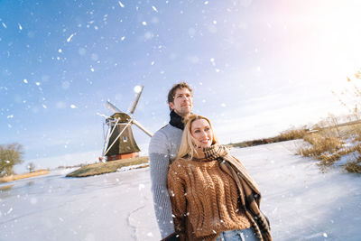 Portrait of smiling woman standing on snow