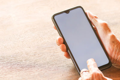 Close-up of hand holding mobile phone