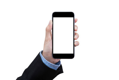 Low section of person holding smart phone against white background