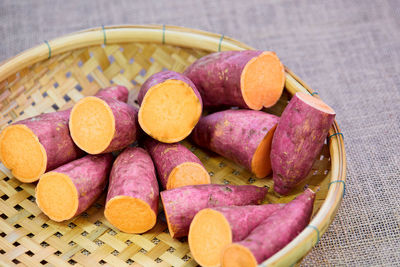 Closeup cut of raw sweet potato in wicker basket