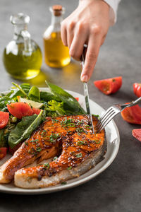 Cropped hand of person having food on table