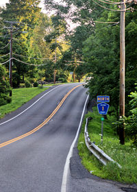 Road sign by trees