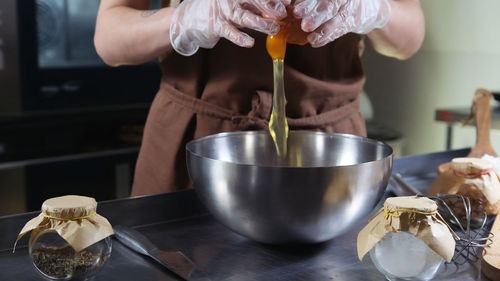 Midsection of woman preparing food on table