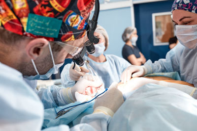 Female dentist examining patient at clinic