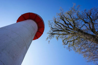 Low angle view of bare tree against clear blue sky