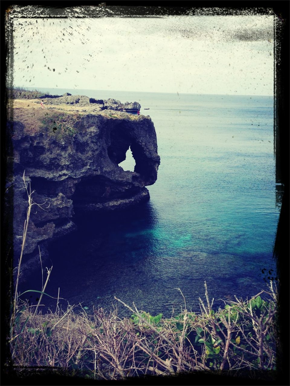 water, sea, tranquil scene, tranquility, transfer print, scenics, rock formation, beauty in nature, rock - object, nature, cliff, horizon over water, auto post production filter, rock, sky, idyllic, non-urban scene, remote, non urban scene, geology