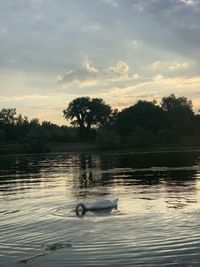 Scenic view of lake against sky during sunset