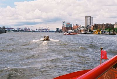 Scenic view of sea and cityscape against sky